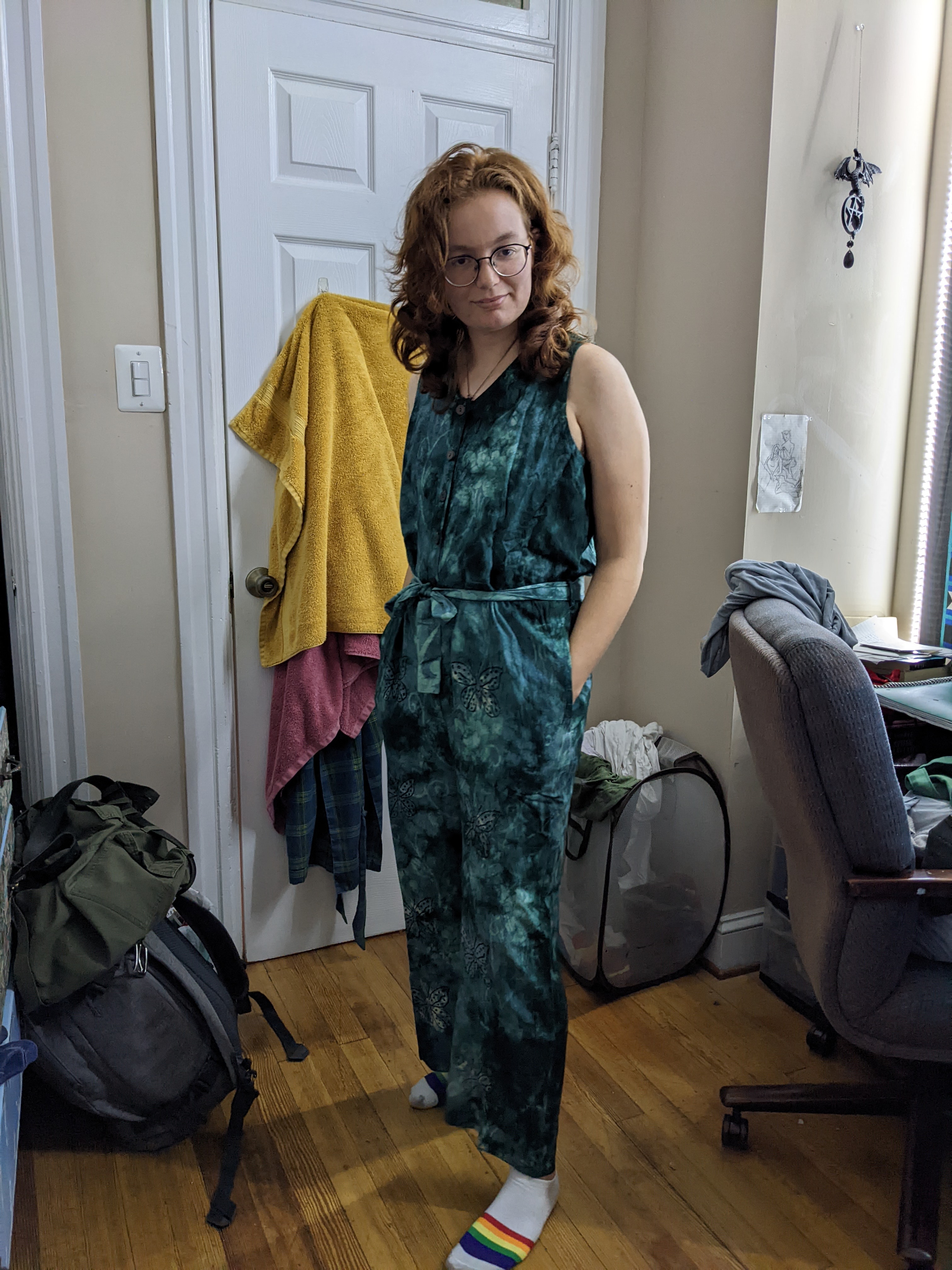 A photo of a young person in a green jumpsuit.